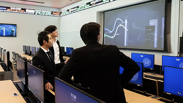 UCR business students viewing a projected graph